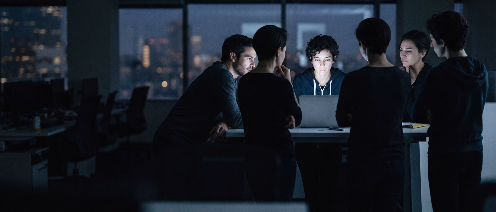 A small group watching a working demonstration on a laptop